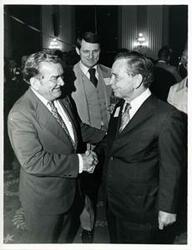 ["Black and white photograph print of Carl Albert shaking hands with Clement Zablocki at his birthday party, 1976"]