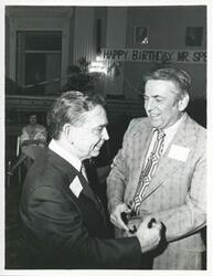 ["Black and white photograph print of Carl Albert with unidentified people at his birthday party, 1976"]