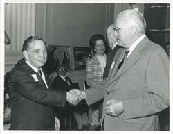 ["Black and white photograph print of Carl Albert with unidentified people at his birthday party, 1976"]