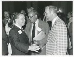 ["Black and white photograph print of Carl Albert with an unidentified people at his birthday, 1976"]