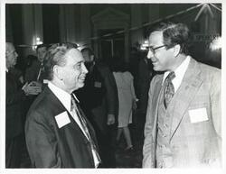 ["Black and white photograph print of Carl Albert with an unidentified people at his birthday, 1976"]