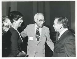 ["Black and white photograph print of Carl Albert with an unidentified people at his birthday, 1976"]