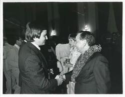["Black and white photograph print of Carl Albert speaking with an unidentified man at his birthday party, 1976"]