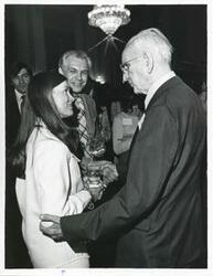 ["Black and white photograph print of John W. McCormack talking to a woman at Carl Albert's birthday party, 1976"]