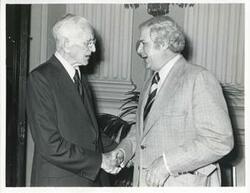 ["Black and white photograph print of John W. McCormack shaking hands with Congressman Morgan Murphy at Carl Albert's birthday party, 1976"]