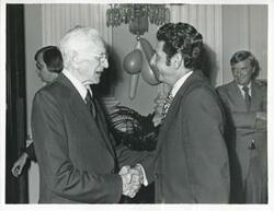 ["Black and white photograph print of John W. McCormack shaking hands with Congressman Leo Zefferetti at Carl Albert's birthday party, 1976"]
