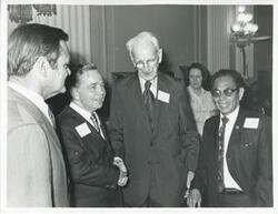 ["Black and white photograph print of Gillis Long, Carl Albert, John W. McCormack, and Tony Won Pat standing together at Albert's birthday, 1976"]