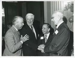 ["Black and white photograph print of Thomas P. O'Neill, Carl Albert, John W. McCormack, and another man talking at Albert's birthday party, 1976"]