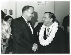 ["Black and white photograph print of Carl Albert shaking hands with an unidentified man. Albert's birthday, May 10, 1974"]