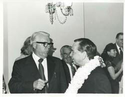 ["Black and white photograph print of Carl Albert speaking with an unidentified man at his birthday party. May 10, 1974"]