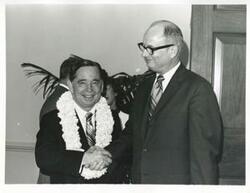 ["Black and white photograph print of Carl Albert shaking hands with Charles Ward at his birthday party. May 10, 1974"]