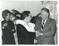 ["Black and white photograph print of Carl Albert shaking hands with an unidentified man at his birthday party. May 10, 1974"]