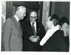 ["Black and white photograph print of Carl Albert, Les Arends, and another man speaking at Albert's birthday party. May 10, 1974"]