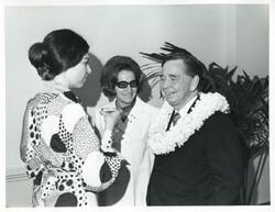 ["Black and white photograph print of Carl Albert speaking with Jane England Lawton and another woman at his birthday party. May 10, 1974"]