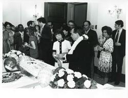 ["Black and white photograph print of Carl Albert and Mary Albert cutting the cake for Mr. Albert's birthday party. May 10, 1974"]