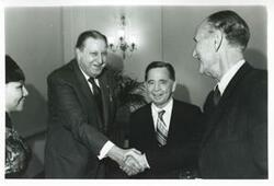 ["Black and white photograph print of Carl Albert standing with Mike Mansfield and another man at his birthday party. May 10, 1974"]