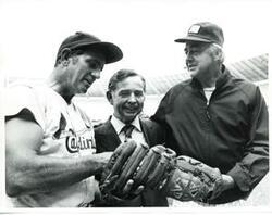["Black and white photograph print of Carl Albert standing between two unidentified baseball players. June 21, 1976"]