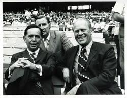 ["Black and white photograph print of Carl Albert and Gerald R. Ford seated at the congressional baseball game. 1972"]