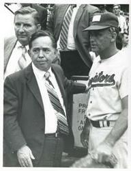 ["Black and white photograph print of Carl Albert standing with an unidentified baseball player at the congressional game, 1972"]