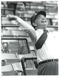 ["Black and white photograph print of Carl Albert throwing in the ball before the baseball game."]