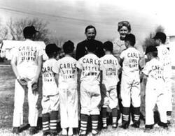 ["Black and white photograph print of Carl Albert speaking with a young baseball team"]
