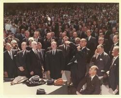 ["Color photograph print of Mike Mansfield, John W. McCormack, Carl Albert, Hubert Humphrey, Lyndon B. Johnson, Lawrence F. O'Brien, Leslie Arends, Gerald R. Ford, Russell Long, Everett Dirksen, and others. Johnson is throwing in the baseball. 1965"]