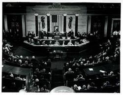 ["Black and white photograph print of Carl Albert and others in the Congressional Chamber."]
