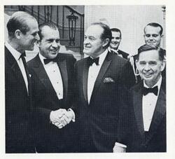 ["Black and white photograph print of Prince Phillip of Great Britain, Richard Nixon, Bob Hope, and Carl Albert. November 24, 1969"]