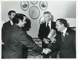 ["Black and white photograph print of Carl Albert speaking with Paul Newman and two unidentified men."]