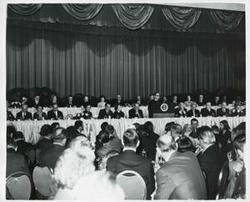 ["Black and white photograph print of Elliot Richardson, John B. Connally, Richard M. Nixon, Pat Nixon, John N. Mitchell, George Romney, Carl Albert and several others at the National Prayer Breakfast. February 2, 1971"]