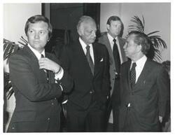 ["Black and white photograph print of Carl Albert talking with unidentified men at breakfast on May 23, 1973"]