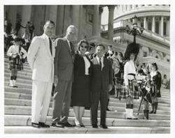 ["Black and white photograph print of John Jarman, A. S. Mike Monroney, Carl Albert, and others standing on the steps of the Capitol."]