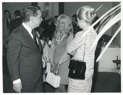 ["Black and white photograph print of Carl Albert speaking with unidentified women."]