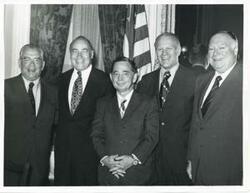 ["Black and white photograph print of Carl Albert, Gerald R. Ford, and three unidentified men posing for a picture. (Ford not pictured in 2809)."]