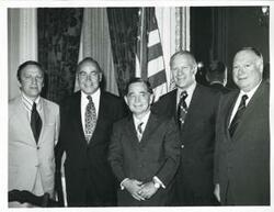 ["Black and white photograph print of Carl Albert, Gerald R. Ford, and John Brademas with others."]
