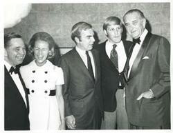 ["Black and white photograph print of Carl Albert, Gerald R. Ford, and three unidentified men posing for a picture. (Ford not pictured in 2809)."]