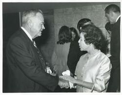 ["Black and white photograph print of Mary Albert shaking hands with Lyle Boren at an unknown function"]