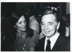 ["Black and white photograph print of Carl Albert speaking with an unidentified woman."]