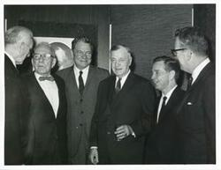 ["Black and white photograph print of John W. McCormack, George Aiken, Hale Boggs, Michael Kirwan, Carl Albert, and Lawrence F. O'Brien at an unknown function."]