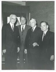 ["Black and white photograph print of John W. McCormack, Hale Boggs, Michael Kirwan, and Carl Albert."]
