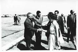 ["Black and white photograph print of Carl Albert and Mary Albert with others at an airport. House delegation trip. August 1975"]