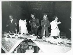 ["Black and white photograph print of Mary Albert with several people during the House delegation trip. August 1975"]