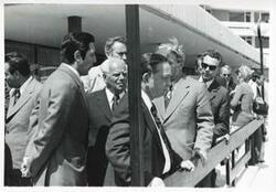 ["Black and white photograph print of Carl Albert standing outside with several other men. House delegation trip. August 1975"]