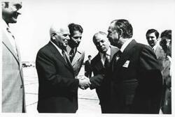 ["Black and white photograph print of Carl Albert shaking hands with an unidentified man. House delegation trip. August 1975"]