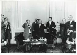 ["Black and white photograph print of Carl Albert toasting a drink with several other men during the House delegation trip. August 1975"]