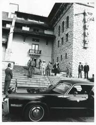 ["Black and white photograph print of Carl Albert standing with several people outside a building during the House delegation trip. August 1975"]