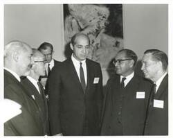 ["Black and white photograph print of Carl Albert speaking with several unidentified men at the Eighth Meeting of the Panel on Science and Technology 1967"]