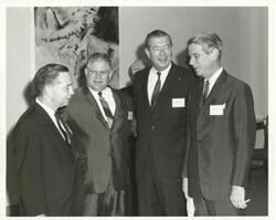 ["Black and white photograph print of Carl Albert, Olin Teague, and two other men speaking at the Eighth Meeting on Science and Technology 1967"]