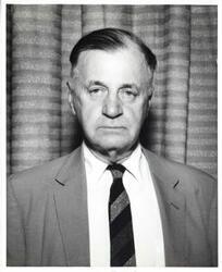 ["Black and white photograph print of a close-up of Michael J. Kirwan."]