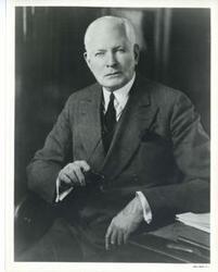 ["Black and white photograph print of studio portrait of Elmer Thomas."]